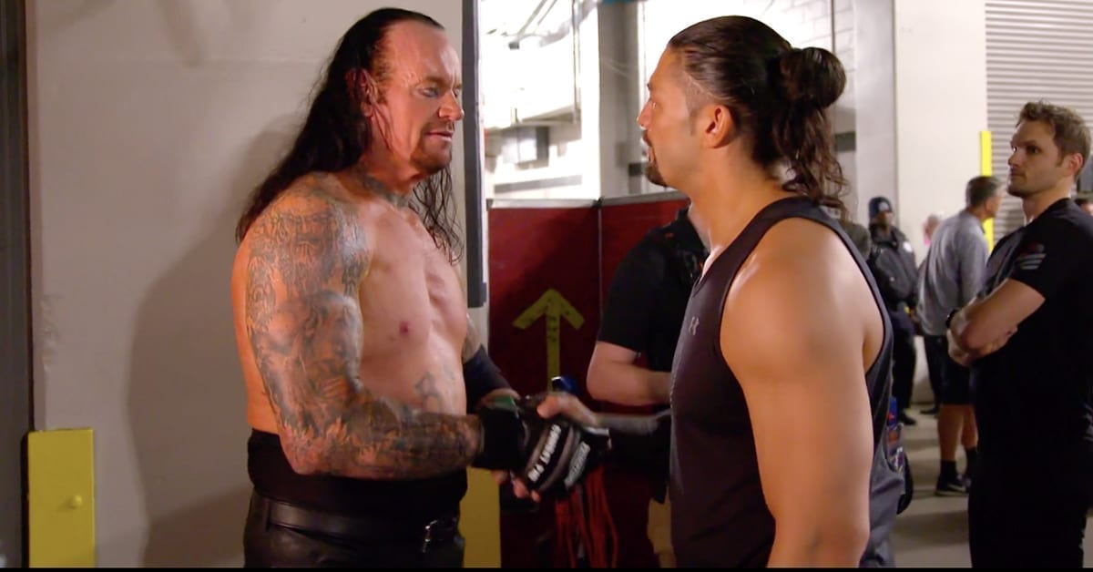 The Undertaker and Roman Reigns shake hands backstage at WrestleMania 34