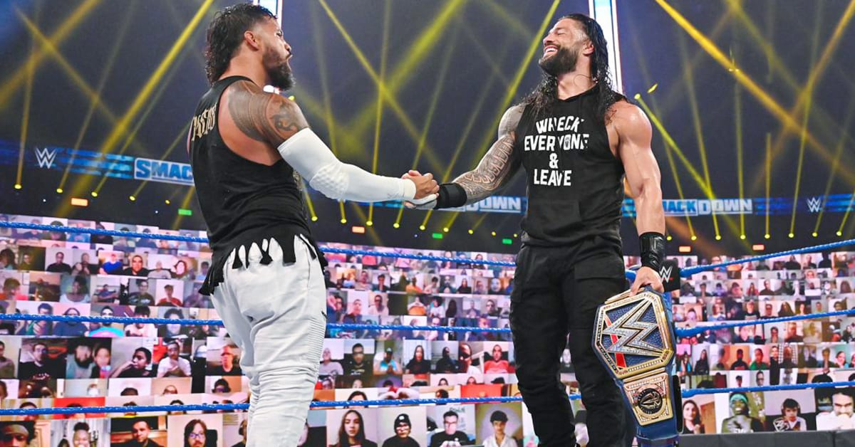 Jey Uso Roman Reigns Holding Hands Smiling Laughing
