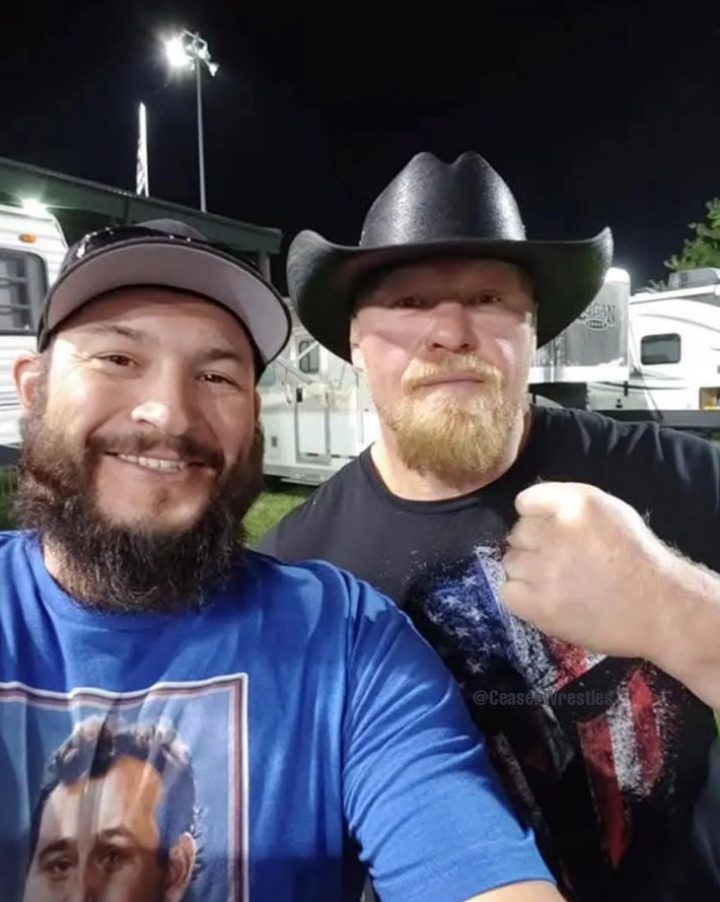 Brock Lesnar posing with a WWE fan March 2025