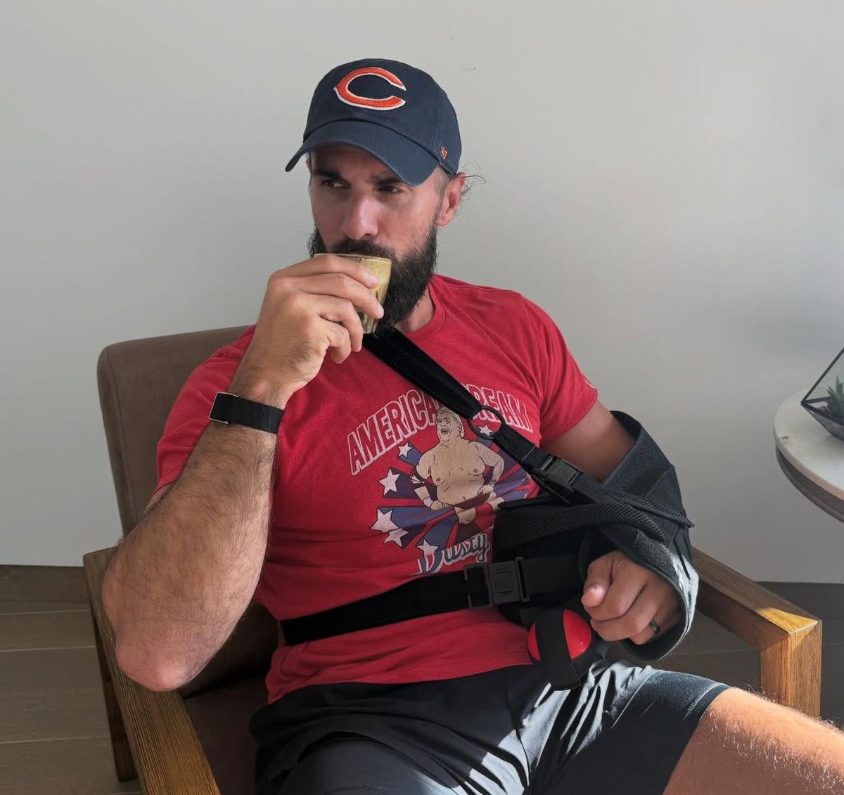 Seth Rollins in a sling after shoulder injury drinking coffee October 2025